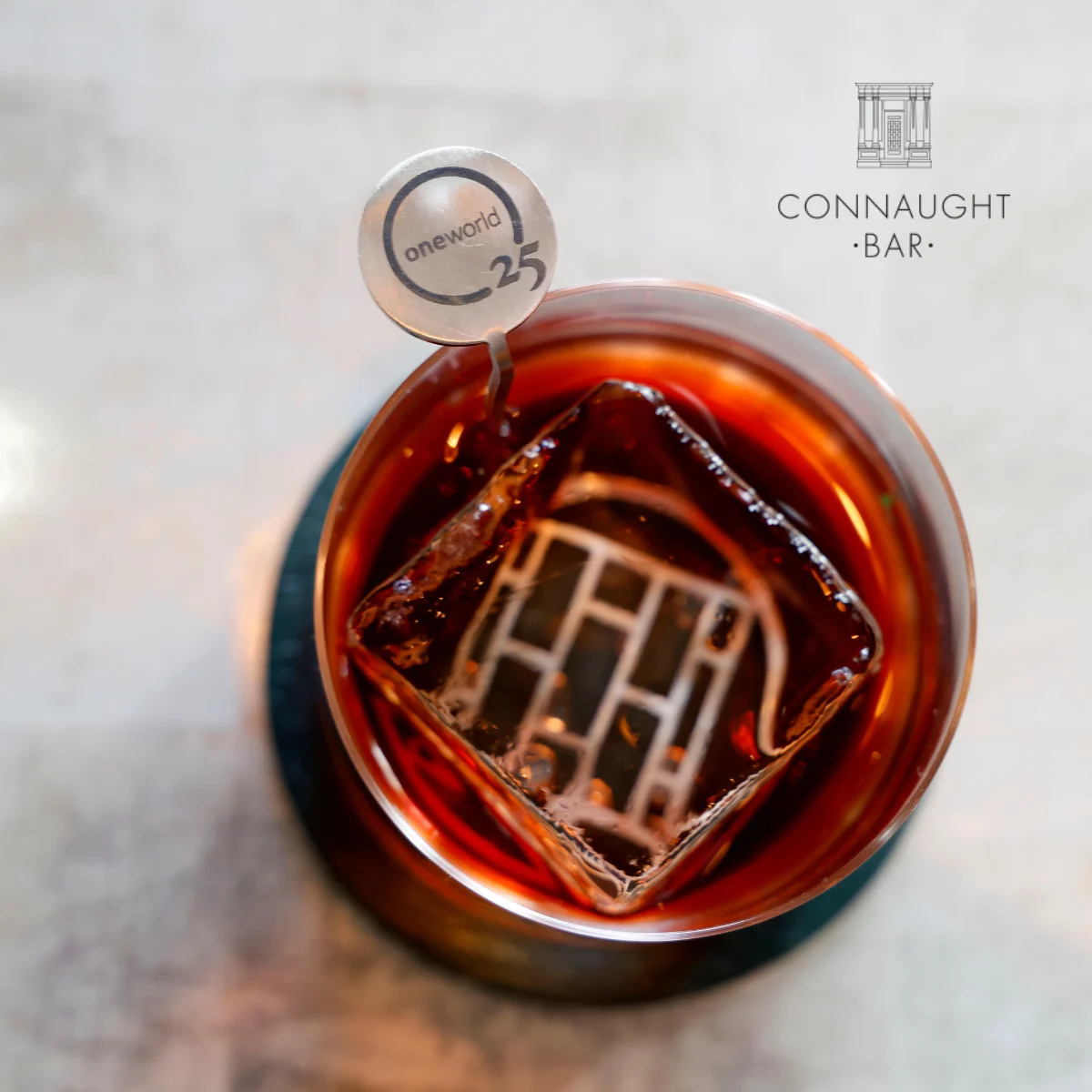 Connaught logo with a cocktail on table 