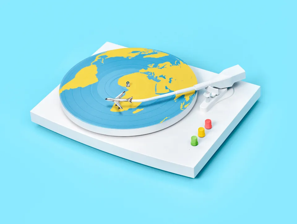 Record player with outline of earth on record and a plane on the stylus