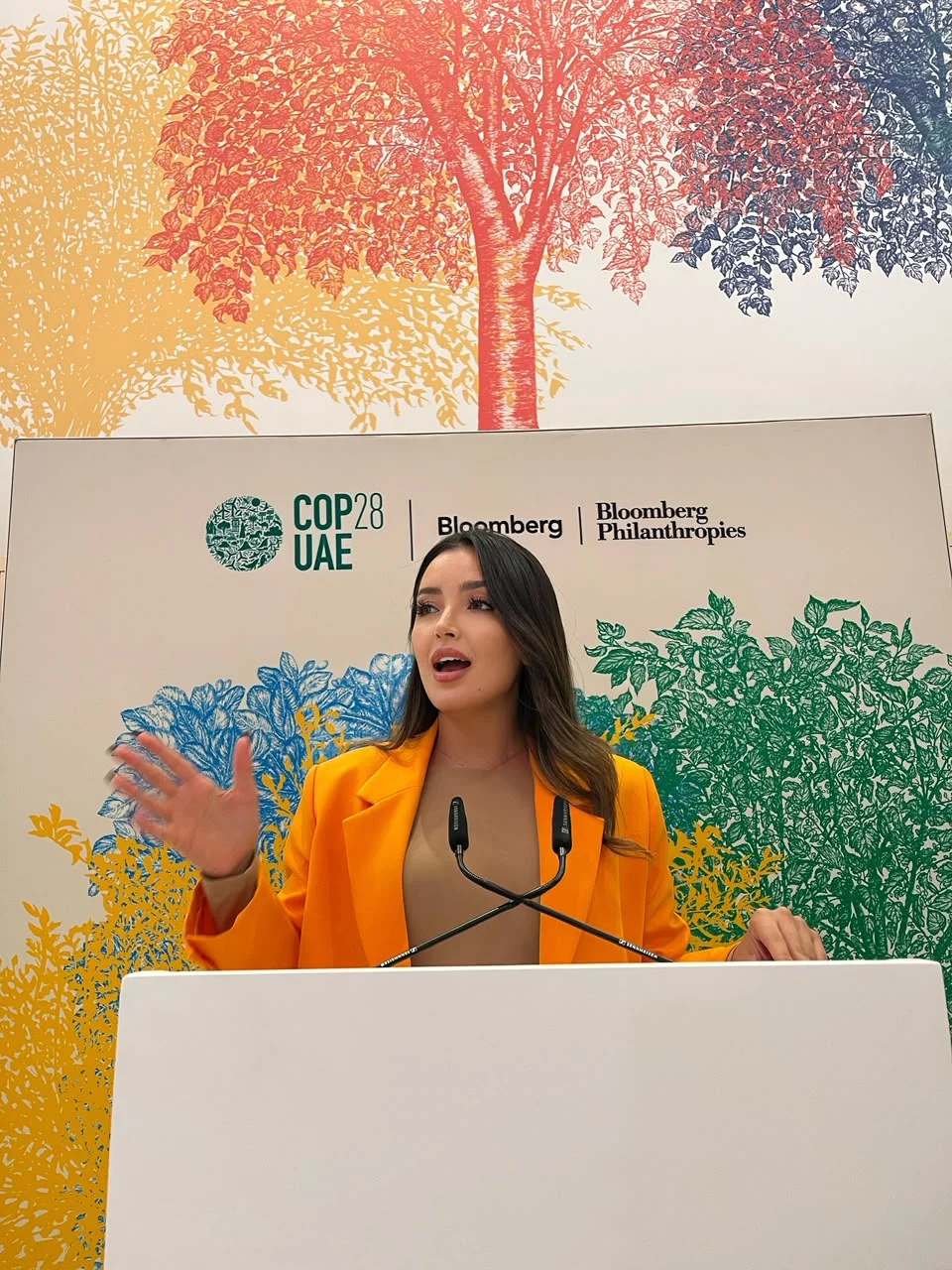 Hasnae Taleb speaking at a COP28 podium
