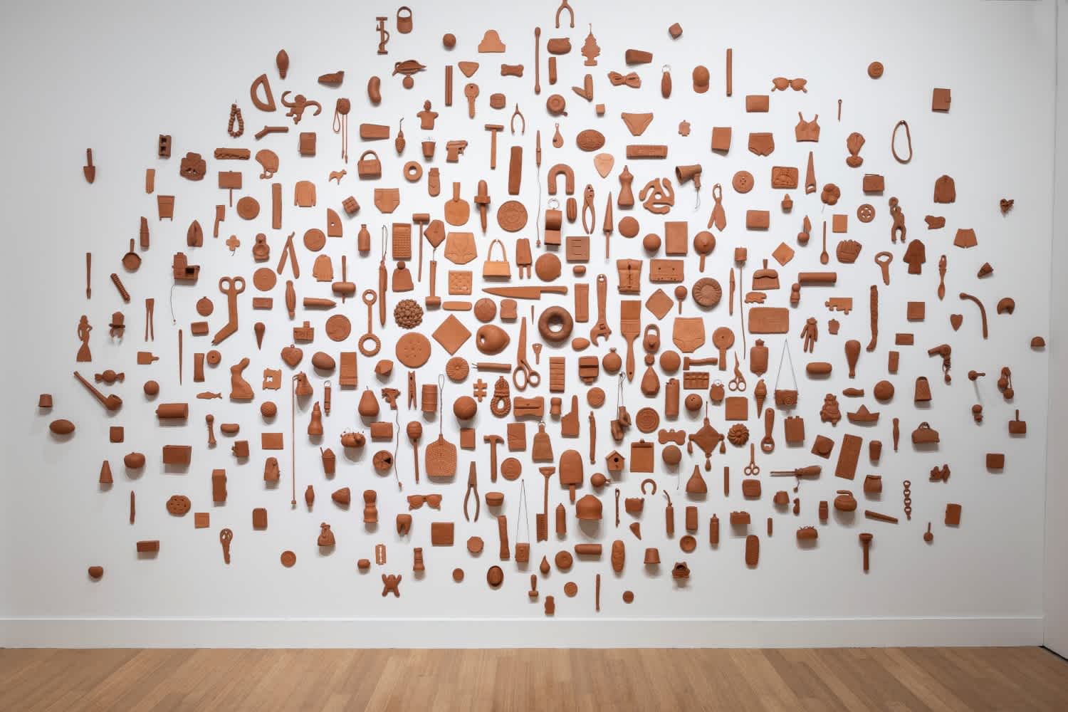 Every Day I Think of You by Pattie Chalmers, an installation of 365 terracotta objects covering an entire gallery wall at the Virginia Museum of Contemporary Art (Virginia MOCA). Featured in the exhibition Shaping Memories: Expressions in Clay.