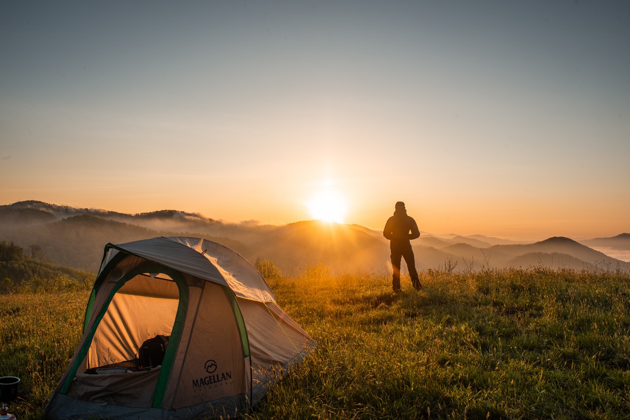 silhouette-of-person-standing-near-camping-tent-2398220