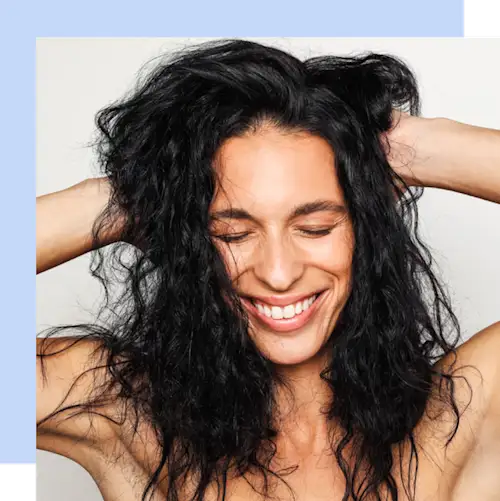 Woman smiling hands on her head