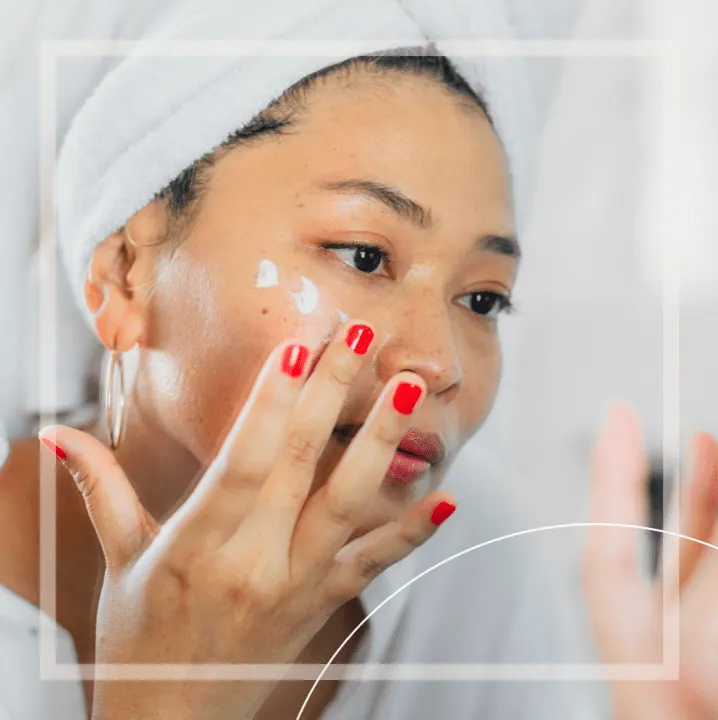 Lady in robe putting on cream
