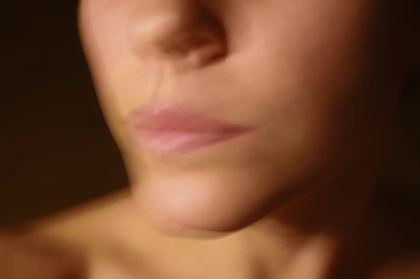  Woman's lower face in movement, blurred. AW111