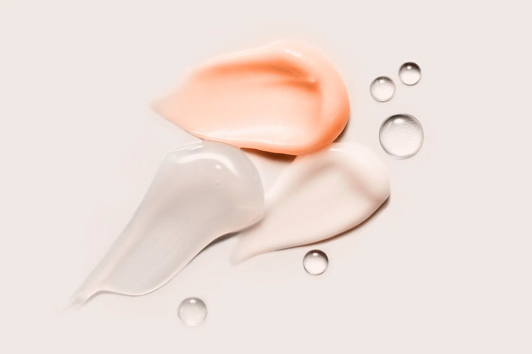 AW756 swipes of four skincare products on pale peach background with moisture droplets header