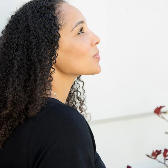 Biracial woman with long ringlets looking up in profile.  AW164