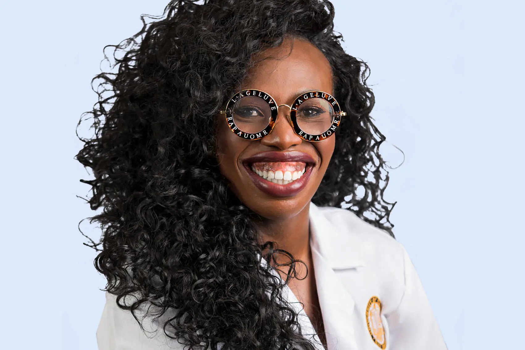 Dr.Maria Uloko smiling in round glasses wearing lab coat - header