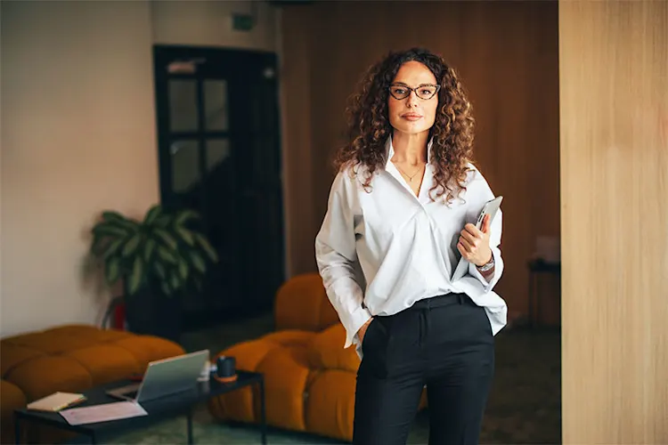 Woman putting on earrings for work