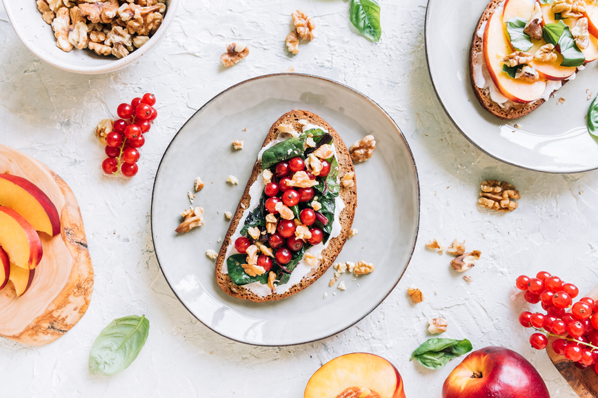 Overhead view - whole grain bread, nuts and fresh fruits and basil. AW084 
