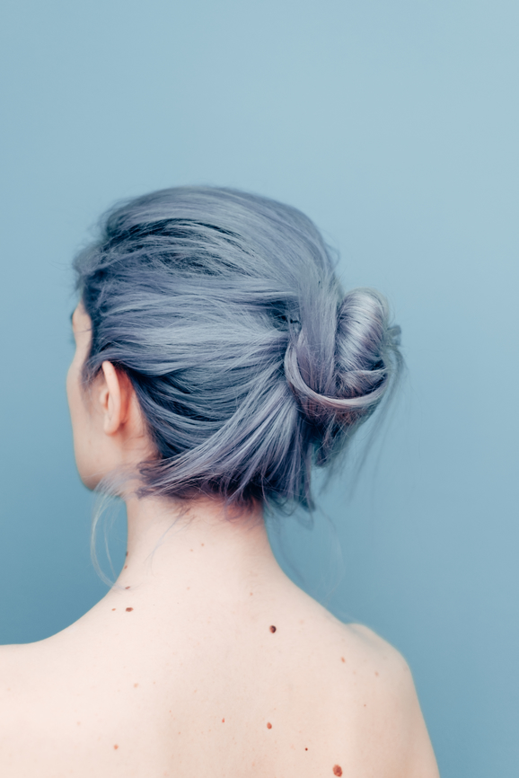AW161 Does Menopause Cause Hair Loss? (photo showing rear view of woman with bare shoulders, hair dyed blue tied in bun)