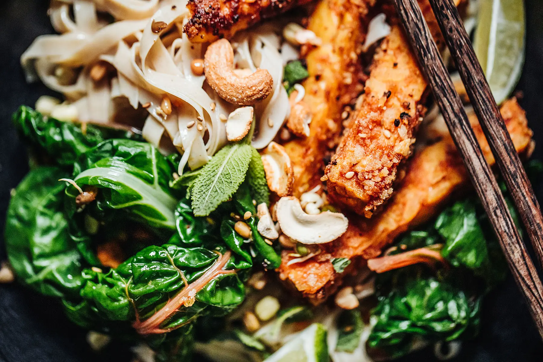 Tempeh on a bed of kale, mint, and noodles.  AW536