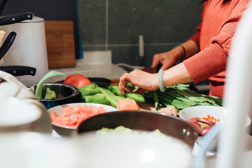 Woman preparing vegetables in kitchen. AW070