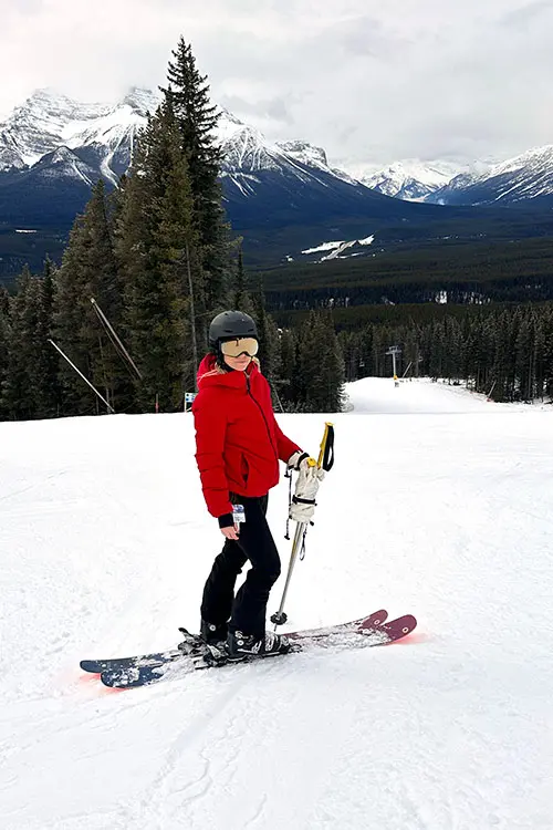 Hayden Mills in red ski parka on snowy slope.