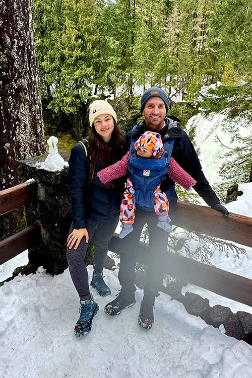 Olivia Berkus with her family in snowy forest.