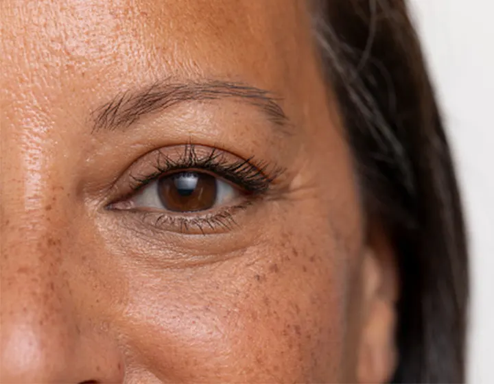 Woman with dark hair & eyelashes