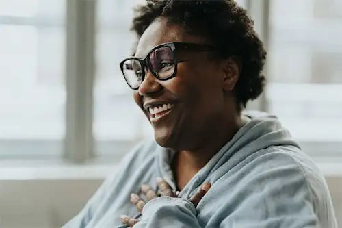 Black woman wearing bold framed eyeglasses getting hrt consult