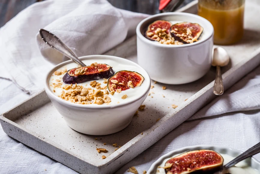 Bowls of greek yogurt topped with figs on tray. AW209