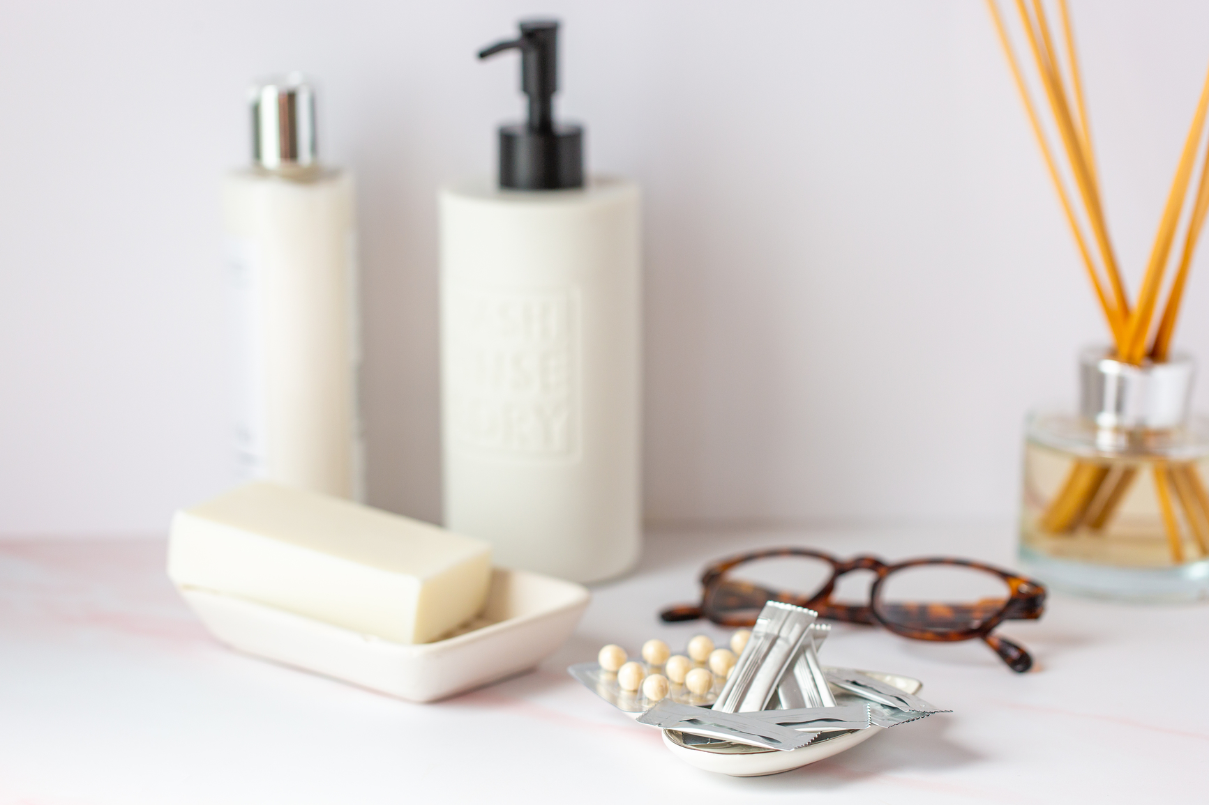 AW175 Why Estrogen? (top) (photo showing bathroom vanity with still life of beauty products, eyeglasses and a tray of estrogen and progesterone products)