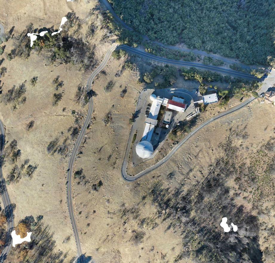 An aerial view of a building on a hill.