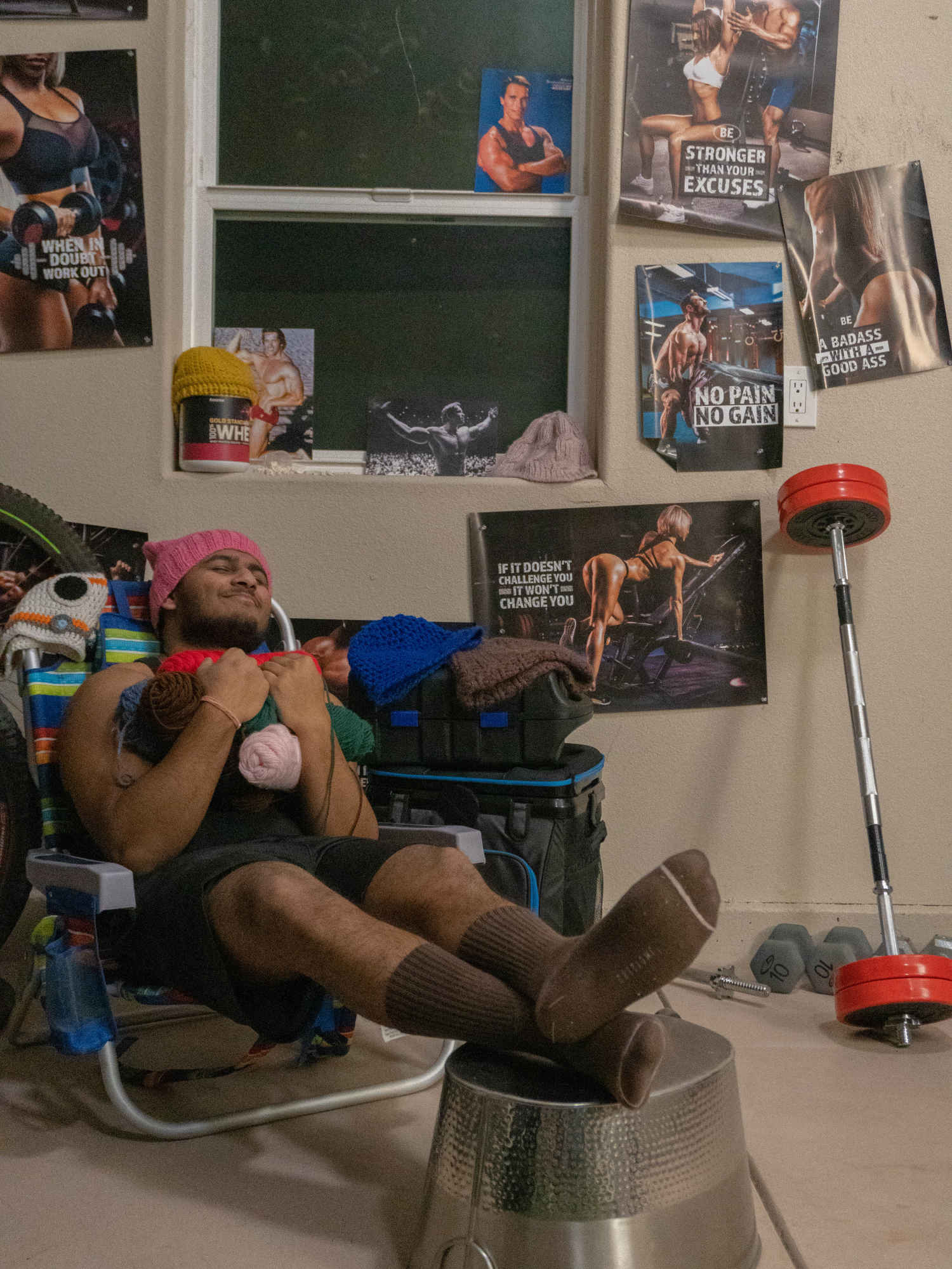 A man sitting in a chair in his room.