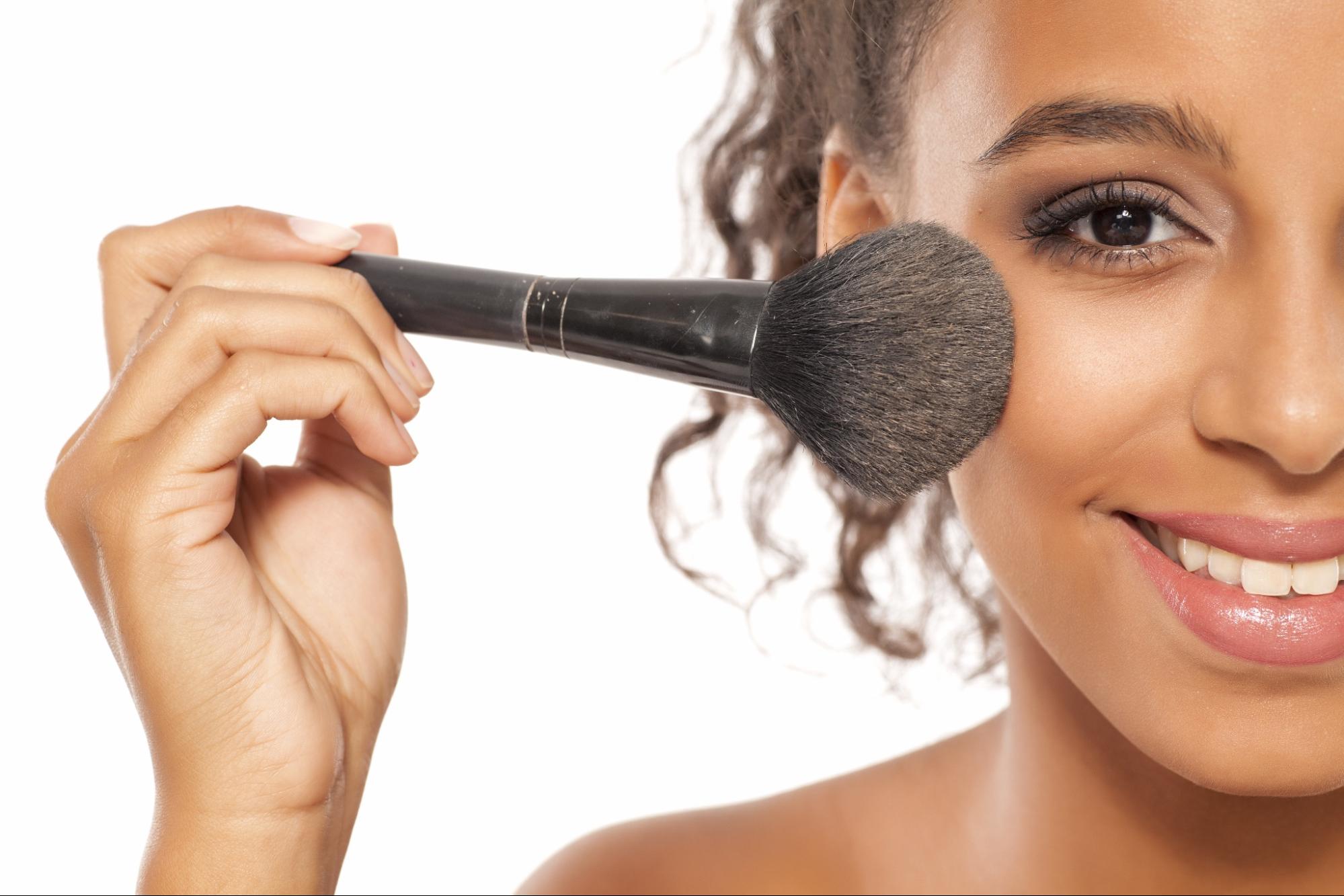 Smiling Woman Holding a Makeup Brush