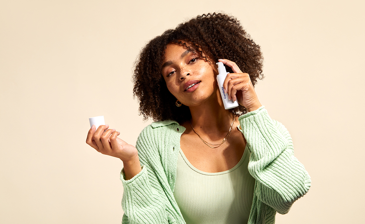 Woman Applying Curology Custom Formula to Cheek Acne