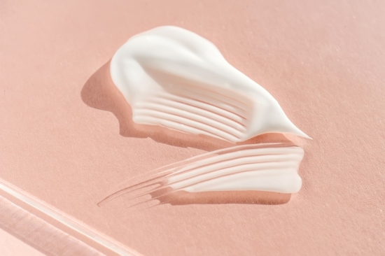 white cream on pink background