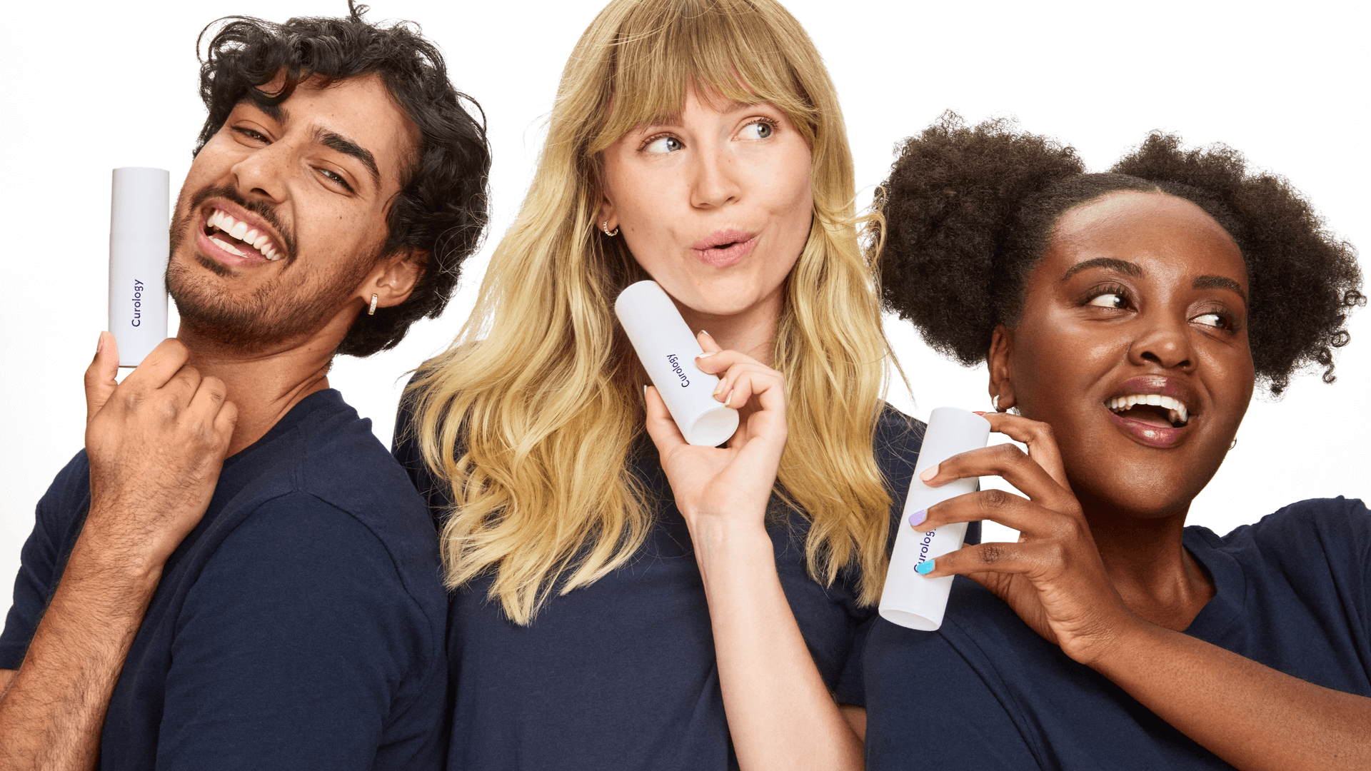 Group of young people smiling while holding their Curology Custom Formula Rx