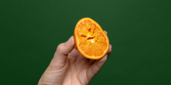 Orange squeezed in hand