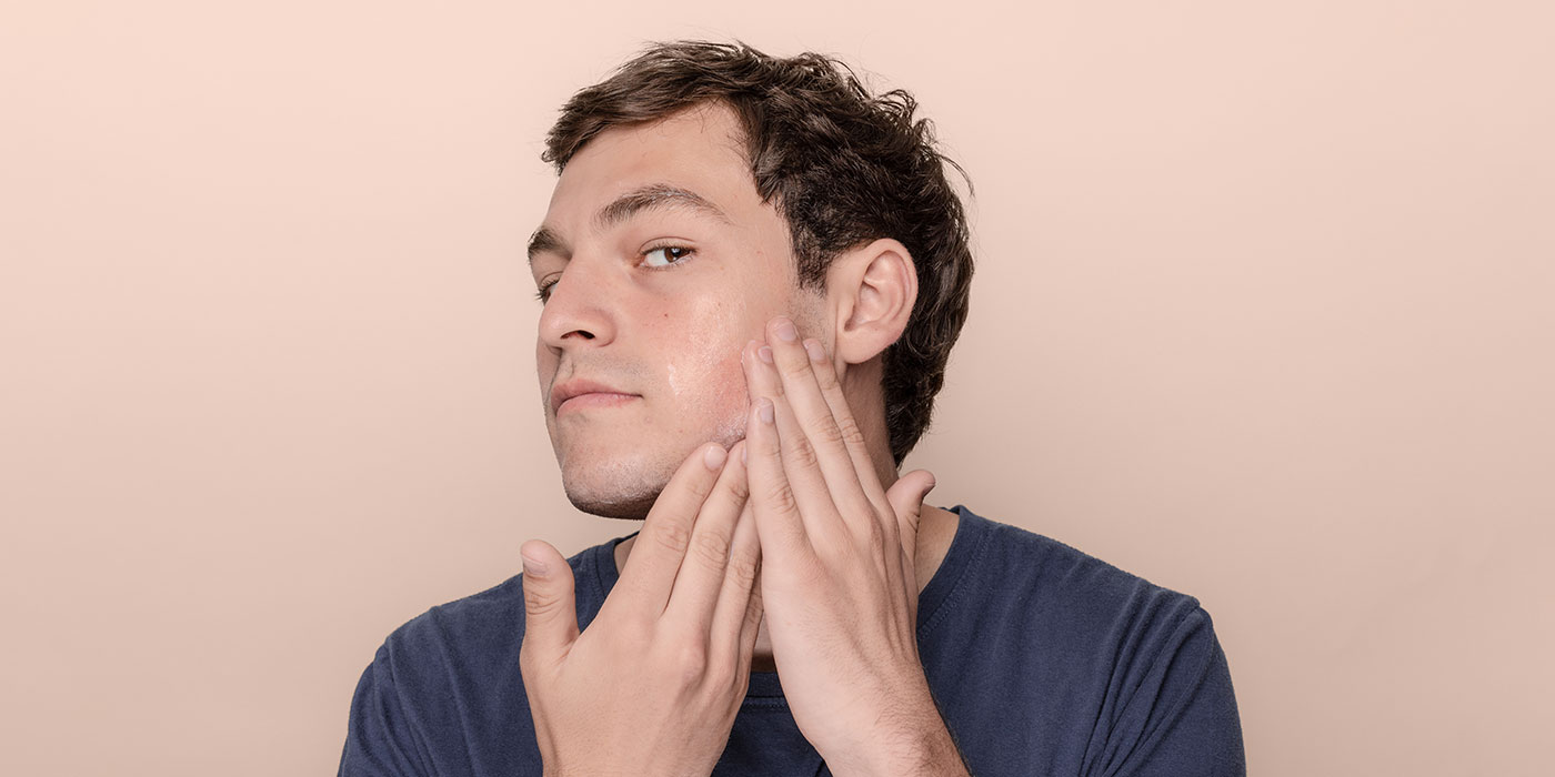 Man moisturizing his skin
