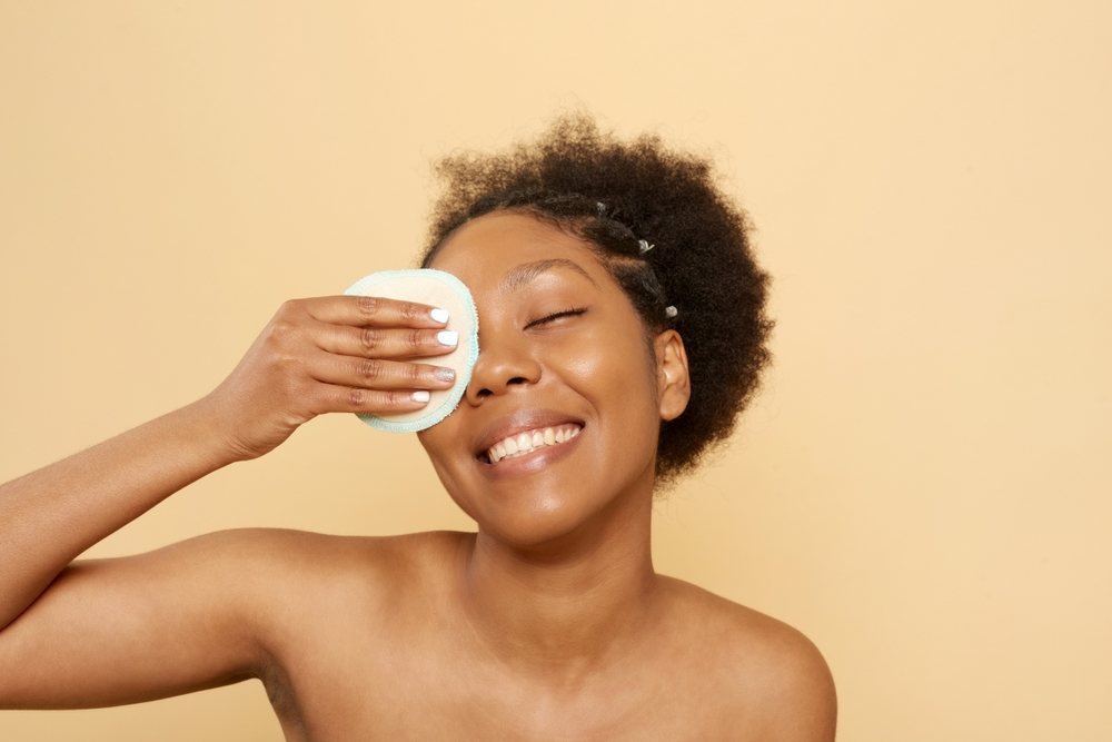young woman removing makeup