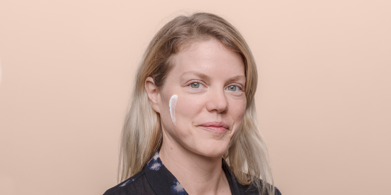 Women with cream product on cheek