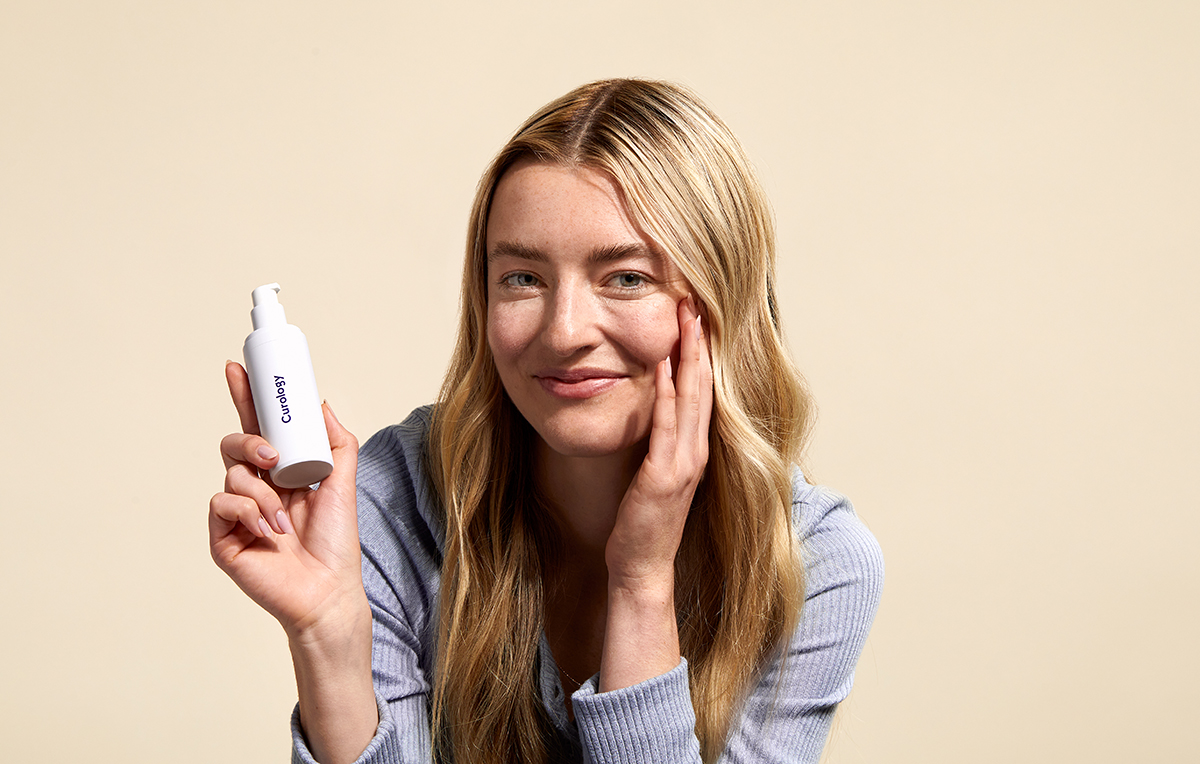 Image of Woman Holding Curology Custom Skincare Formula