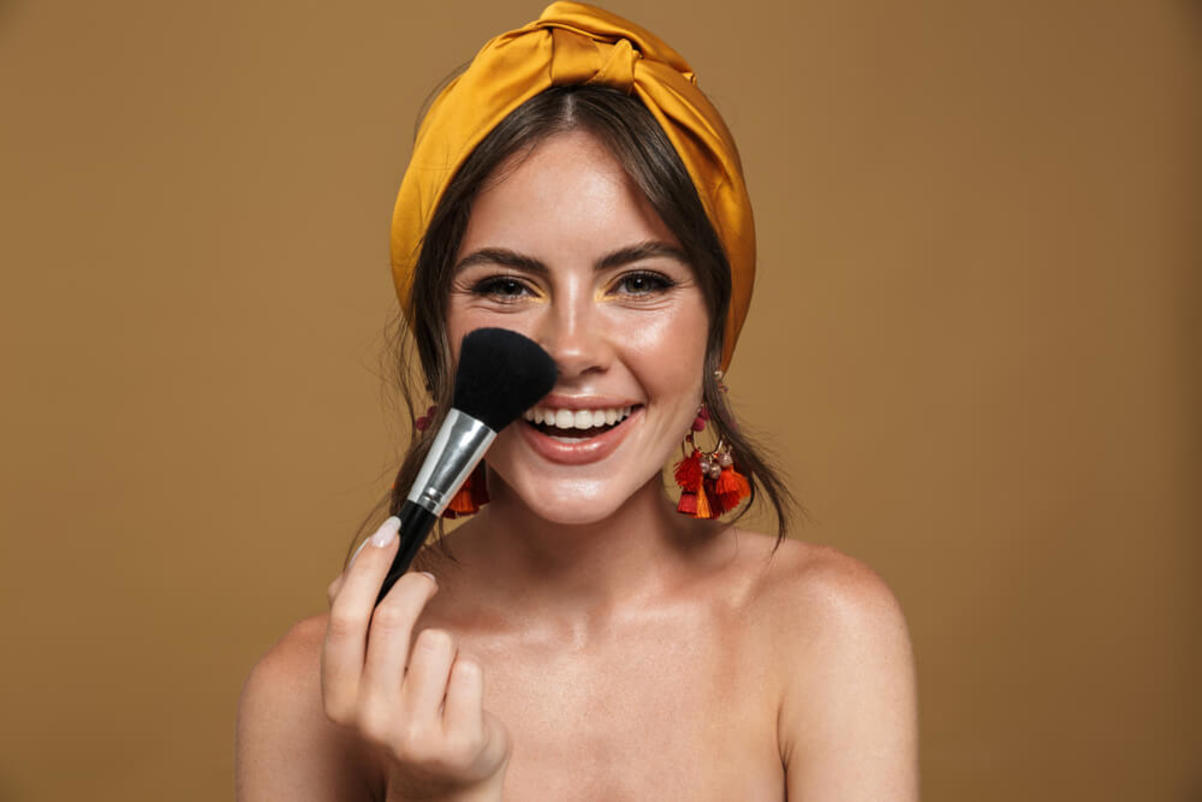 Woman Holding Makeup Brush