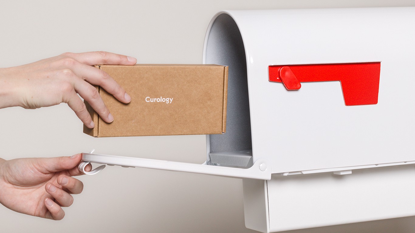 Curology box being placed in white mailbox