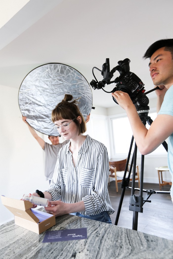 Photography set of Hallie Bing opening curology box