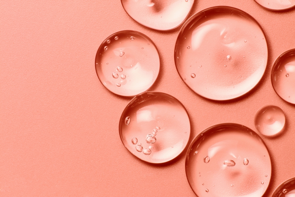 oil drops on salmon pink background