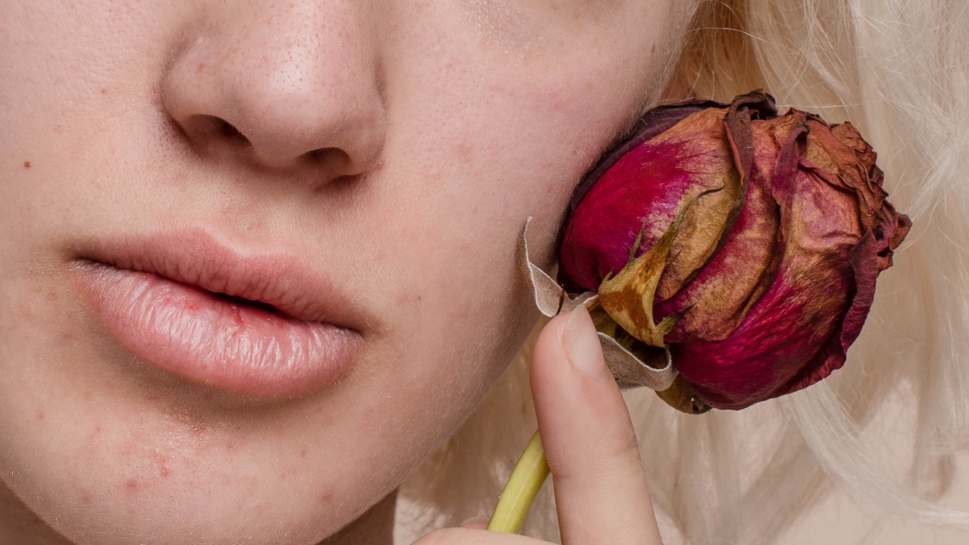 Woman with rose on her face