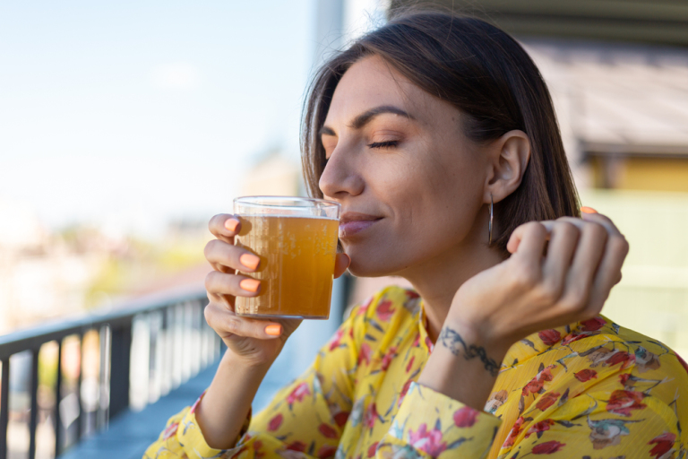 woman enjoying kombucha drink