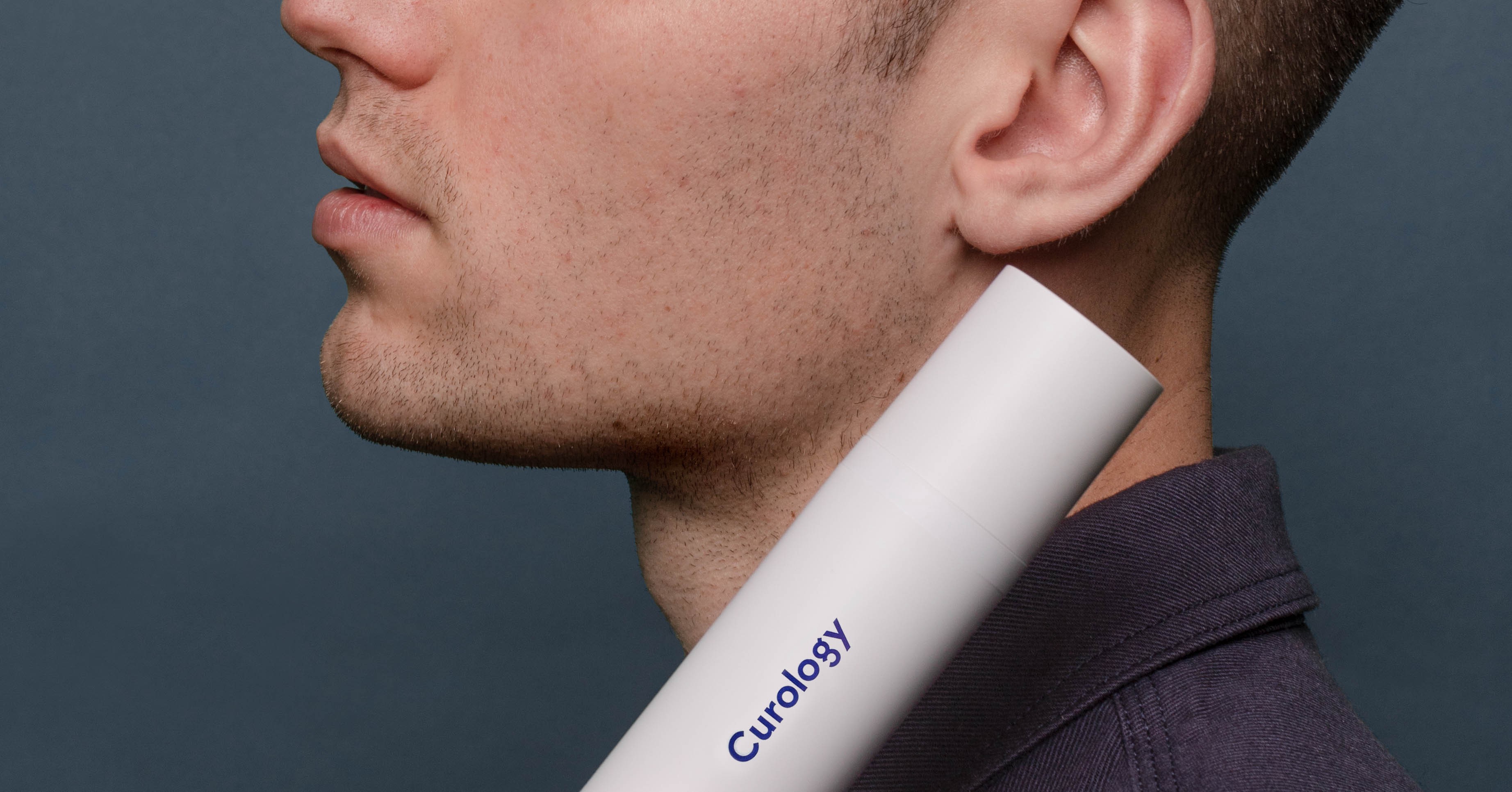 Man holding Curology bottle closeup