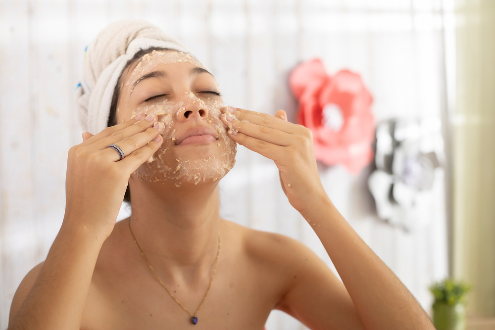 woman washing her face at home