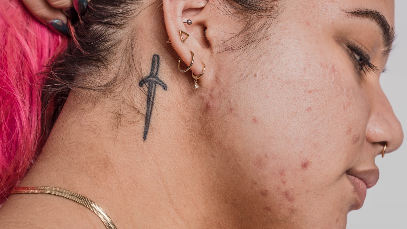 Woman with knife tattoo on her neck