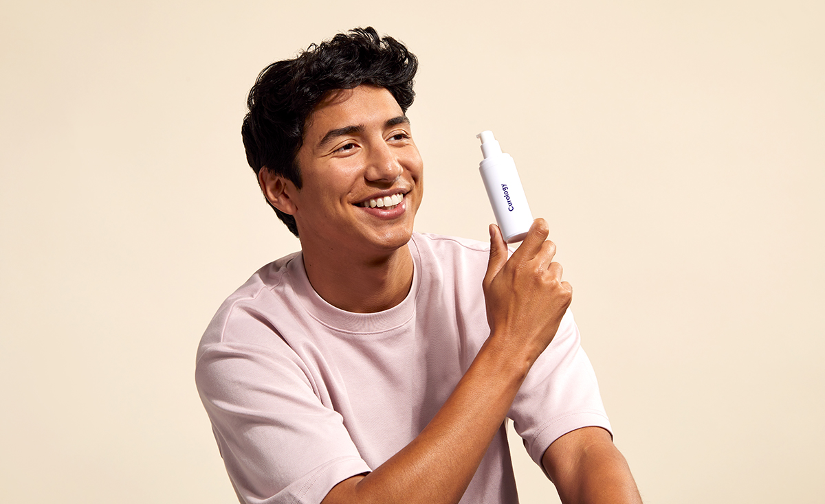 Guy Holding His Curology Custom Formula For Acne Treatment