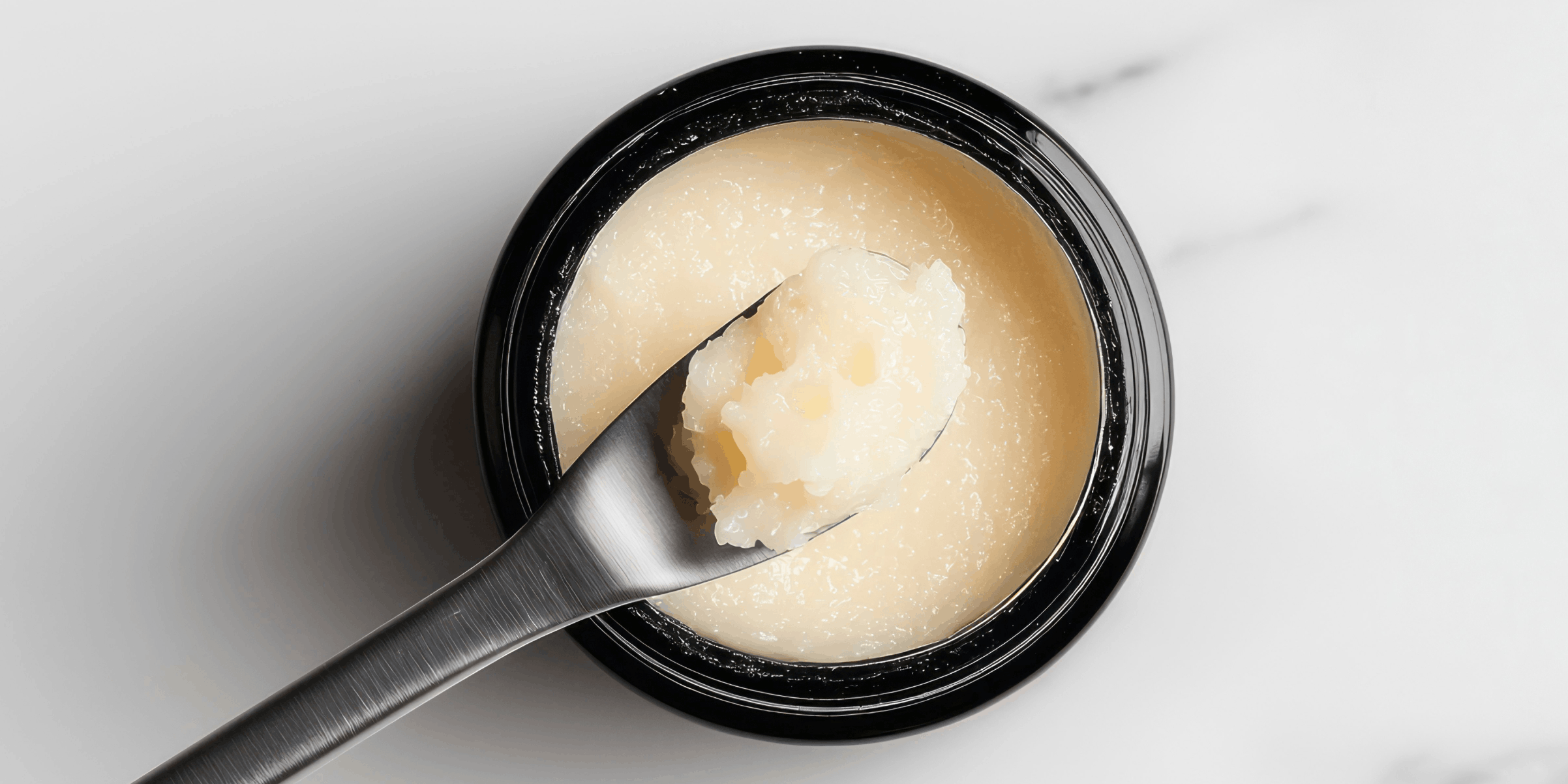Image of beef tallow with application utensil. Curology dermatology providers warn DIY tallow can oxidize and may carry bacterial contamination.