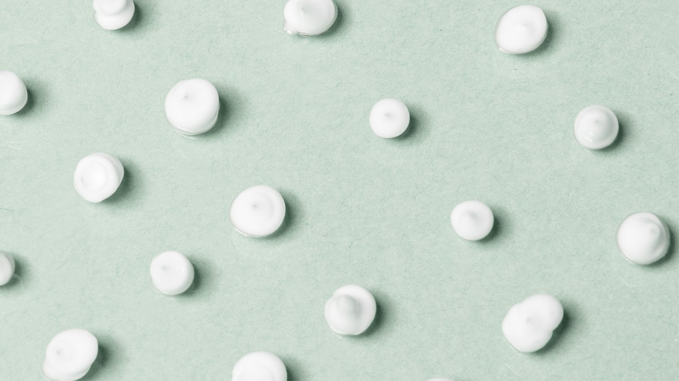 Moisturizer cream against a green background