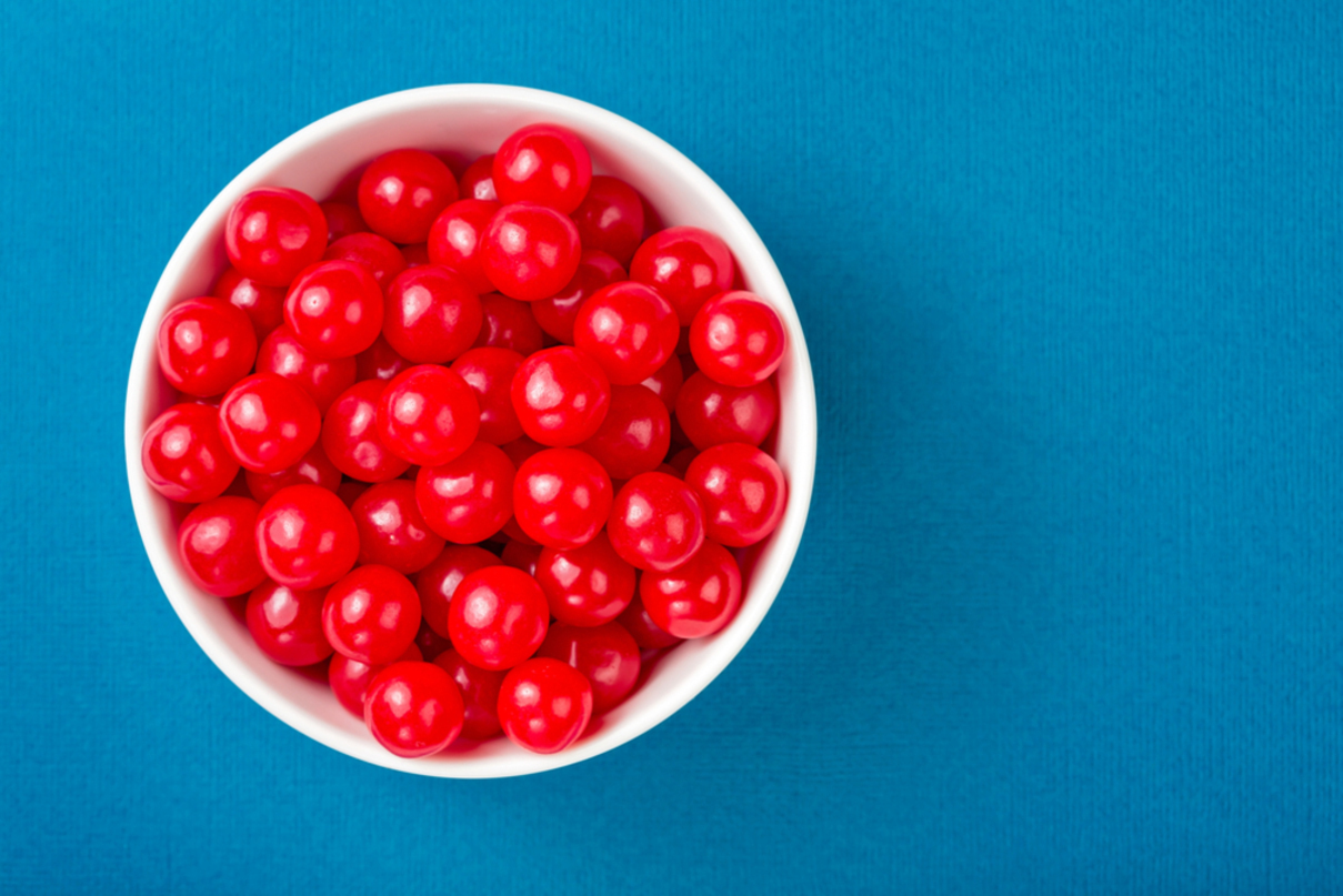 Bowl of red cherries on a blue background