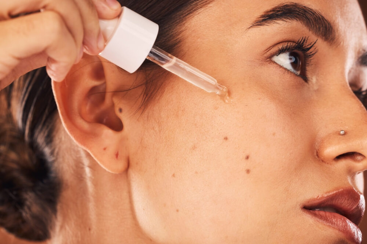 Woman Applying Retinol on the Face