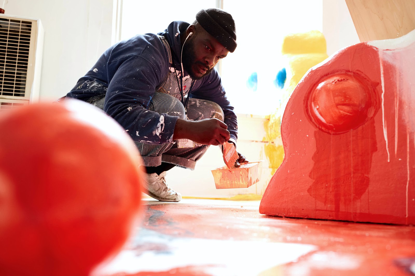 Man paining artwork on the ground | Keith Magruder