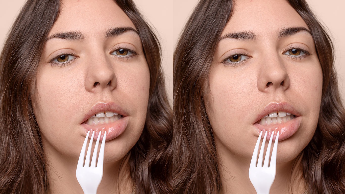 Woman with fork on her lip