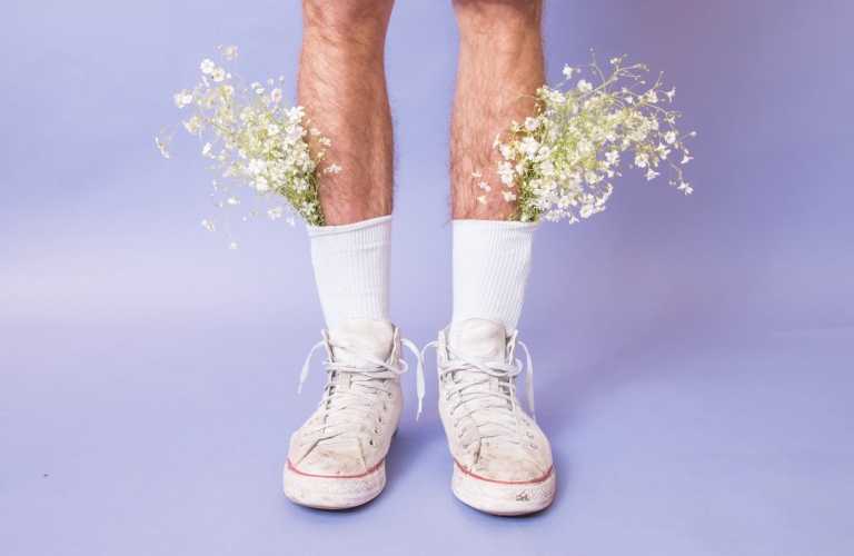 Flowers coming out of white shoes with high socks